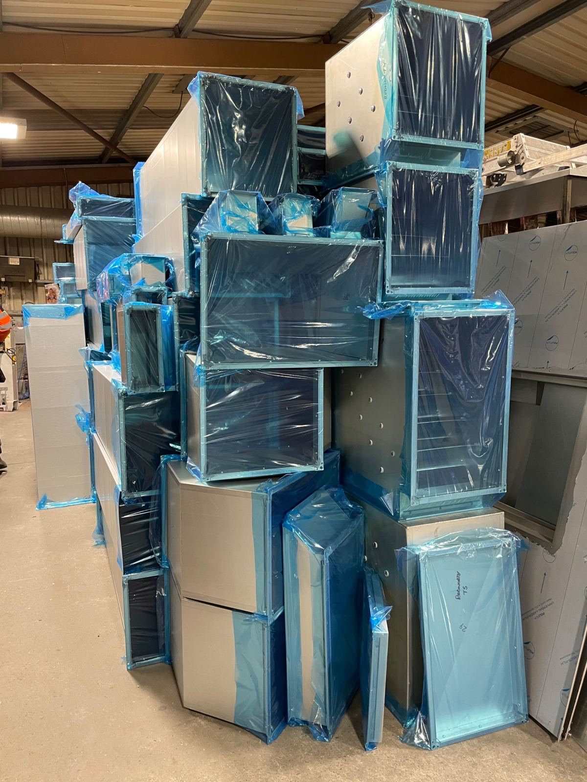 Blue wrapped ductwork prepared for delivery